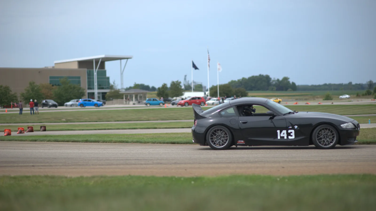 Specialty auto moving through a controlled performance driving course.